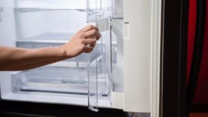 person-cleans-fridge
